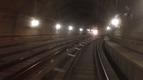 Subway train crosses another train and stops in a station 스톡 동영상 112350095