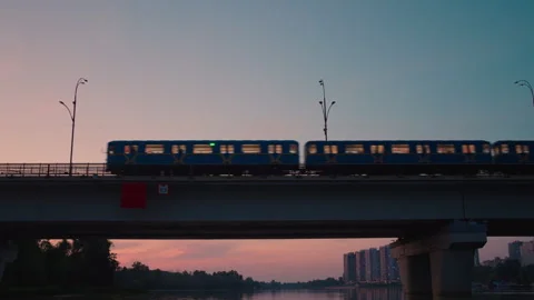 Subway Train Crossing Bridge Over River at Sunset | Metro Railway Silhouette Stock Footage 344062648