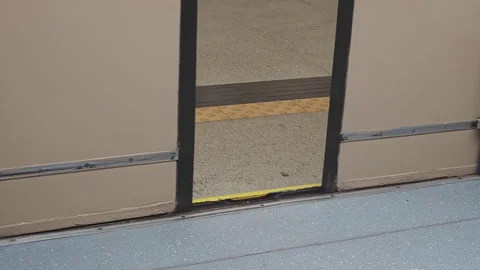 Subway train doors closing automatically on the platform threshold, showing Stock Footage 348174246