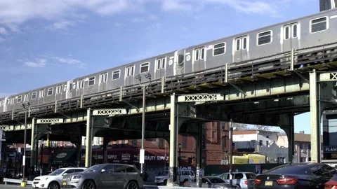 Subway Train on elevated train tracks in Queens. Subway passing by Stock Footage 200797356
