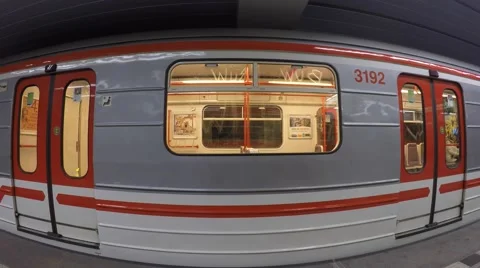Subway train filmed from side view leaving station with acceleration Stock Footage