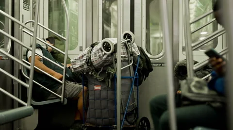 Subway Train Homeless Man Sleeping Passengers New York City NYC USA Stock Footage