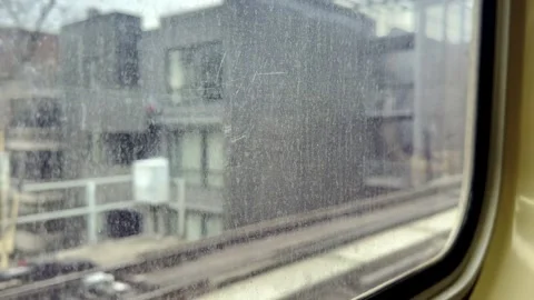 A subway train moves along its track, showcasing a wall covered in graffiti.. Stock Footage 301359511