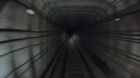 Subway train moving fast at dark tunnel. Speed underground train riding in Stock Footage 329612996