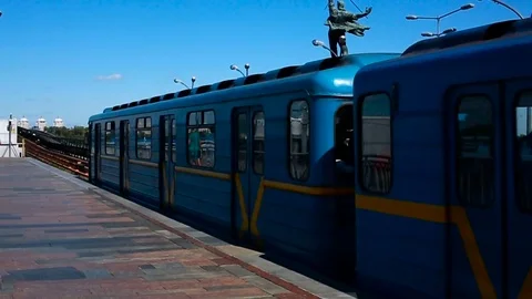 A subway train passes a station underground Stock Footage 79709452