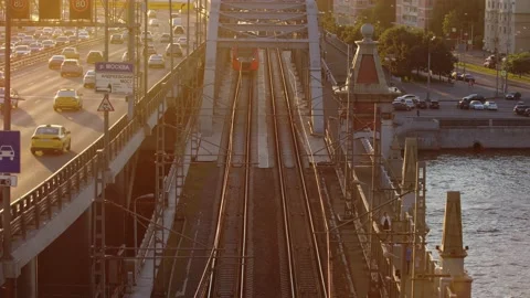Subway Train passing bridge on the bridge which is located next to the highway Stockbeeldmateriaal 160480088