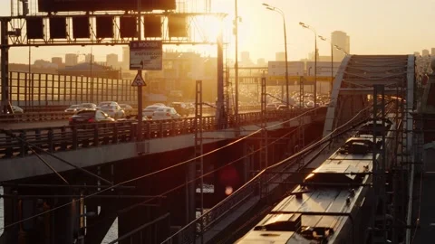 Subway Train passing bridge on the bridge which is located next to the highway Stock Footage 160480666