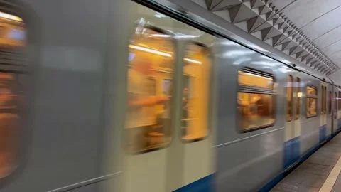 Subway train with people inside moving fast from metro station, close up Stock Footage 276888873