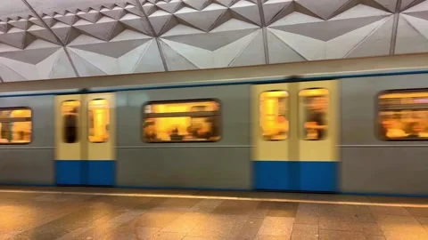 Subway train with people inside moving fast from metro station, close up Stock Footage 276991873