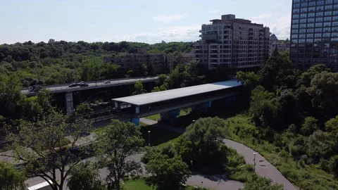 Subway train pulls out of above ground station and pans over to i 動画素材 137109002