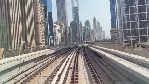 The subway train rides among the glass skyscrapers in Dubai, UAE. Stock Footage 292855853