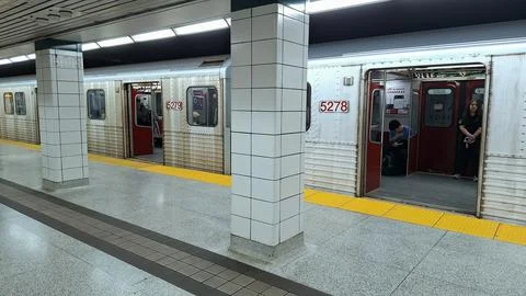 Subway train stopped at a station platform interior view Stock Photos