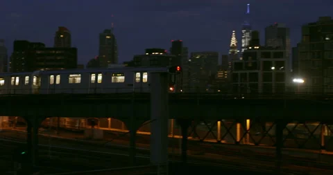A subway train travels through Queens as night falls on New York City. Stock-Footage 231736686