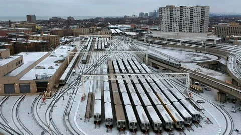 Subway train yard covered in snow with train exiting Stock Footage 101746136