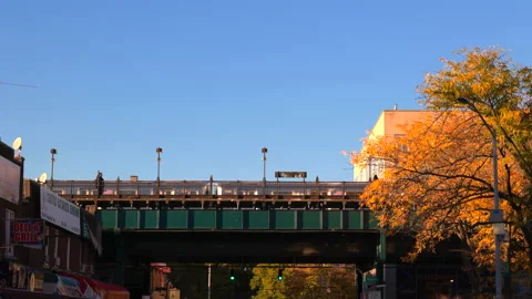 Subway trains run on Elevated Railway track at Jackson Heights in Queens NYC Video stock 230944323