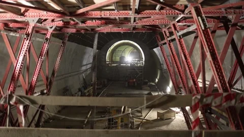 Subway tunnel construction scaffolding and red steel supports frame view into cu Stock Footage 309665565
