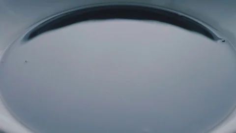 Subwoofer Audio Speaker Vibrations and Black Water Liquid on a Plate Stock Footage 82956519