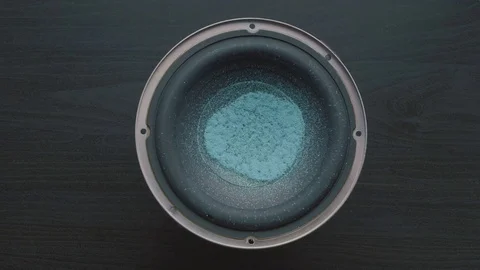 Subwoofer Audio Speaker Vibrations with blue Glitter Sparkles. Overhead Shot. Stock Footage 82956657