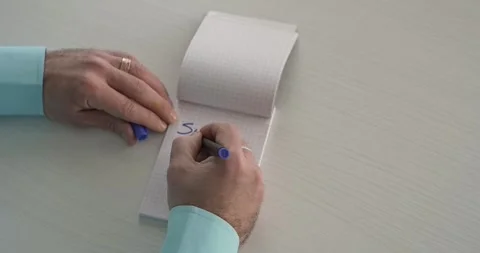 Succes  - this word is written on the sheet by a man's hand Stock Footage 267083274