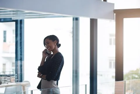 Success is about the commitment you show. a young businesswoman talking on a Foto stock