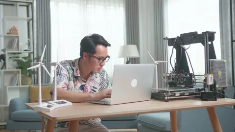 Success Asian Man Working With Model Wind Turbines And 3D Printer At Home Stock Footage 156748343