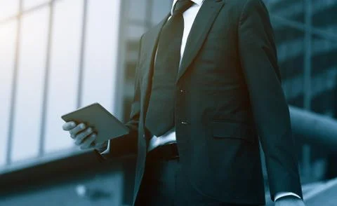 Success business man using tablet phone. Blue Toned Image. Concept businessma Stock Photos