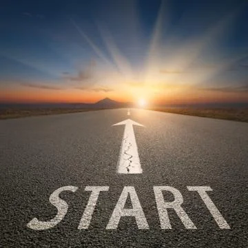 Success concept on an open road with start text at sunset Stock Photos