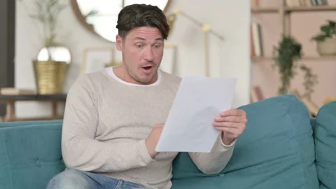 Success on Documents for Young Middle Aged Man, at Home Video stock 142371599