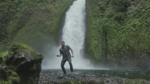 Success man in front of waterfall Stock Footage 44352100