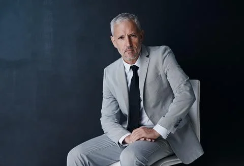 Success is my commitment. Studio portrait of a mature businessman against a dark Stock Photos