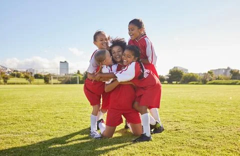Success, soccer or winner children team hug in stadium for sports exercise Stock Photos