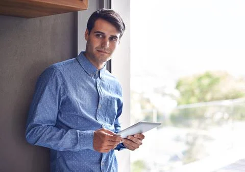 Success is a step-by-step process. Shot of a young businessman standing with a Stock Photos