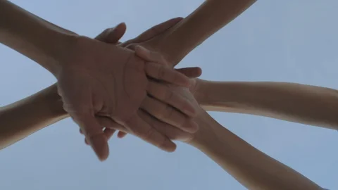 Success team hands holding together on blue sky background Stock Footage 123718345