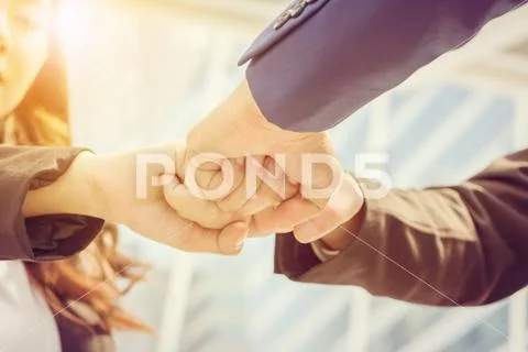 Success Teamwork Concept, Business people joining hands city background Stock Photos