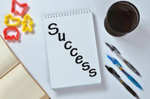 Success text on notepad with office accessories. Business motivation, inspira Stock Photos