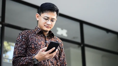 Success young asian guy with cell phone talking with confidence. Stock Footage 95141759