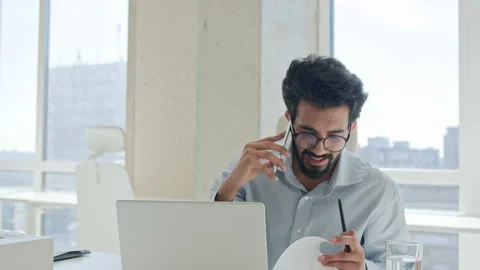 Successful Arabian Indian man multitasking businessman talk mobile phone Stock Footage 250239952