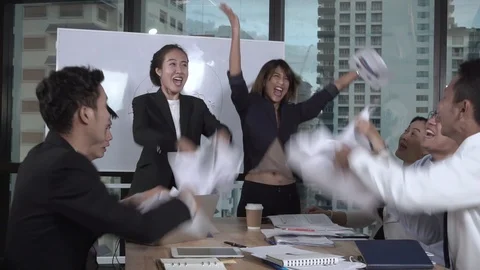 Successful Asian business people celebrate project success in group meeting. Stock Footage