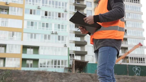 Successful builder engineer stands at construction site in hard hat Stock Footage 117989469