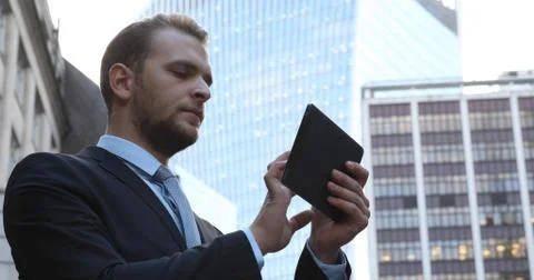 Successful Business Man Use Digital Tablet Searching Online near Office Building Fotos de archivo