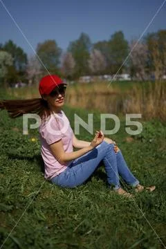 Successful business woman enjoys her leisure free time in a park with blossoming Stock Photos