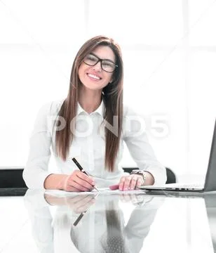 Successful business woman sitting at the office Desk Stock Photos