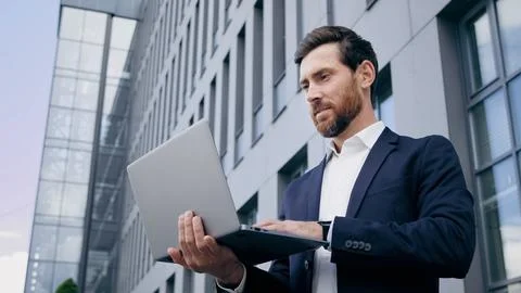 Successful businessman developer creator typing on laptop creates new startup Stock Photos