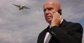 Successful Businessman Have a Mobile Phone Conversation in Airport Landing Area 4k or 4k+ Resolution