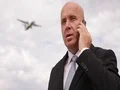Successful Businessman Have a Mobile Phone Conversation in Airport Landing Area 4k or 4k+ Resolution