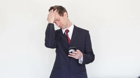Successful Businessman Looking At The Phone Screen and corrects hairstyle Stock Footage 129625341