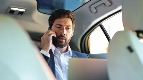Successful Businessman Phone Calling While Working on Laptop in Executive Car Stock-Footage 312866360