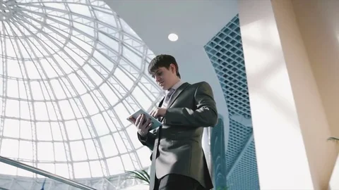 Successful businessman with tablet Stock Footage 77333403