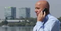 Successful Businessman Talking Mobile About Financial Real Estate Fluctuations 4k or 4k+ Resolution
