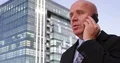 Successful Businessman Talking Mobile About Financial Real Estate Fluctuations 4k or 4k+ Resolution